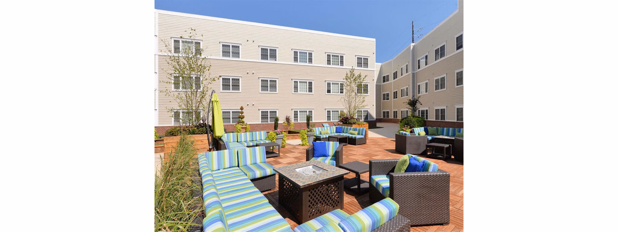 Cozy outdoor fire pit area at The Hawthorne Apartments, perfect for gatherings and relaxation in a tranquil setting