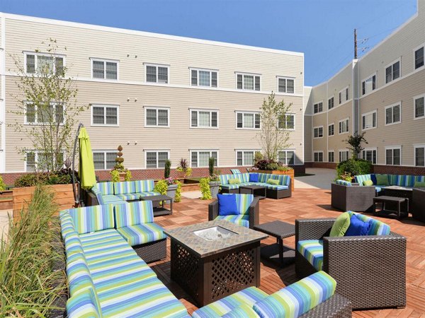 Cozy outdoor fire pit area at The Hawthorne Apartments, perfect for gatherings and relaxation in a tranquil setting