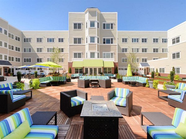 Fire pit lounge area with cozy seating at The Hawthorne Apartments, a luxury living community