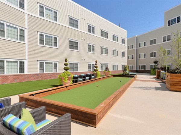 The Hawthorne Apartments: Relaxing courtyard with lush greenery, perfect for outdoor socializing and leisure activities