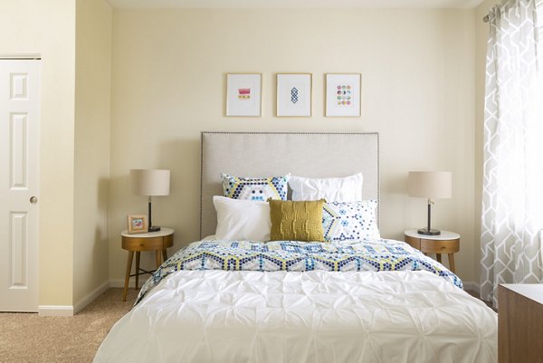 Cozy bedroom featuring modern decor at The Prescott at Concord Apartments