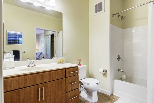 Modern bathroom featuring sleek fixtures and ample lighting at The Prescott at Concord Apartments
