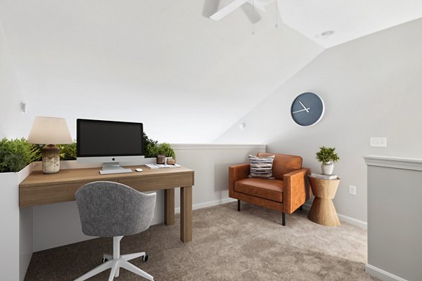 Home office with modern desk and ergonomic chair at The Prescott at Concord Apartments