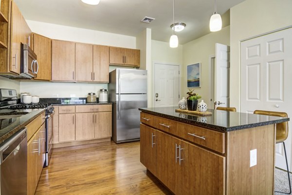 Modern kitchen featuring stainless steel appliances at The Prescott at Concord Apartments
