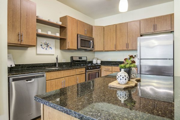 Modern kitchen with stainless steel appliances at The Prescott at Concord Apartments