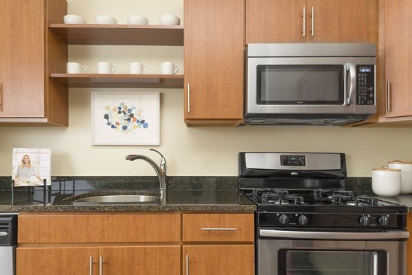 Modern kitchen with stainless steel appliances at The Prescott at Concord Apartments