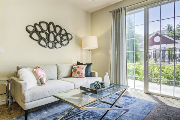 Elegant living room with modern decor at The Prescott at Concord Apartments