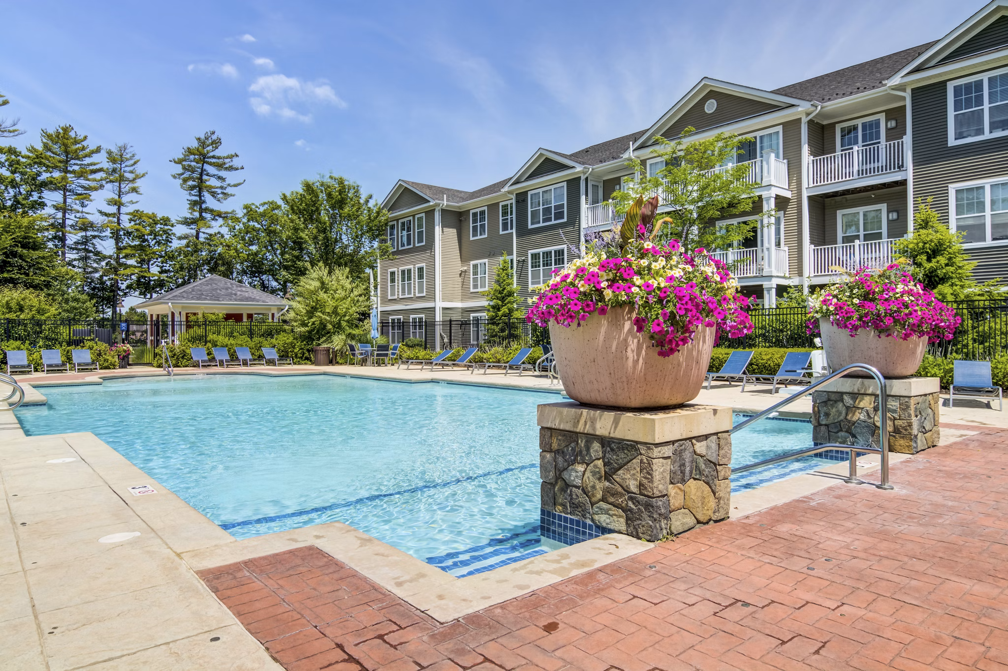 Resort-style pool with loungers at The Prescott at Concord Apartments