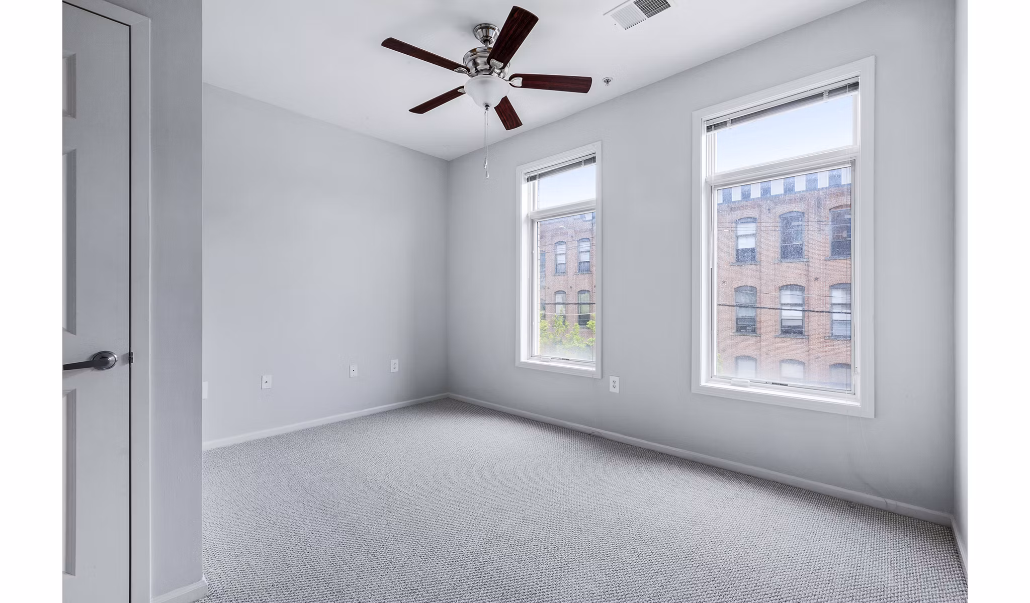 Luxurious bedroom with plush bedding and city views at 1000 Jefferson Street Apartments