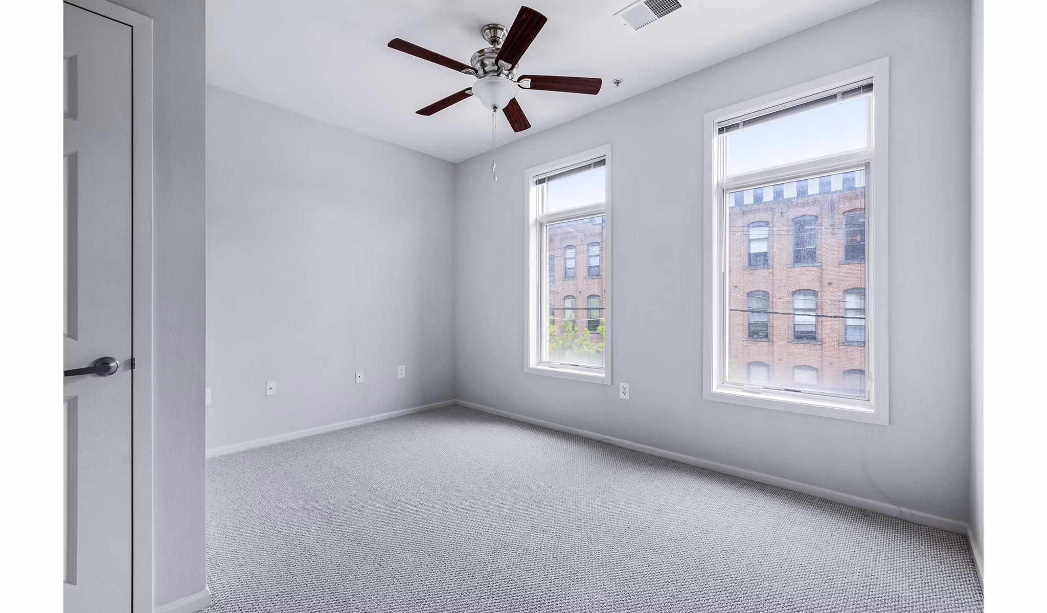 Luxurious bedroom with plush bedding and city views at 1000 Jefferson Street Apartments