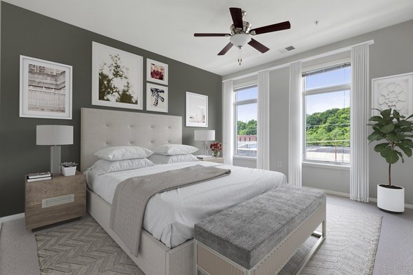 Spacious bedroom with modern furnishings at 1000 Jefferson Street Apartments in Greystar luxury community