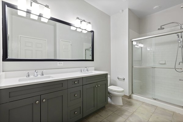 Modern bathroom with sleek fixtures and ample lighting in 1000 Jefferson Street Apartments