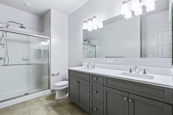 Elegant bathroom with marble countertops and modern fixtures at 1000 Jefferson Street Apartments