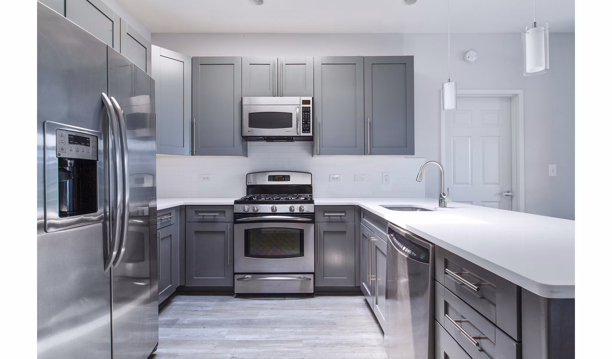 Modern kitchen featuring stainless steel appliances at 1000 Jefferson Street Apartments