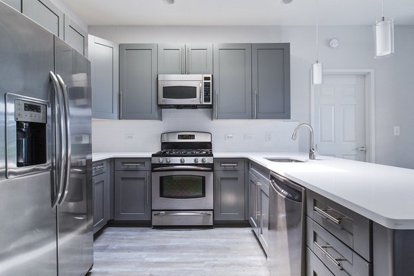 Modern kitchen featuring stainless steel appliances at 1000 Jefferson Street Apartments