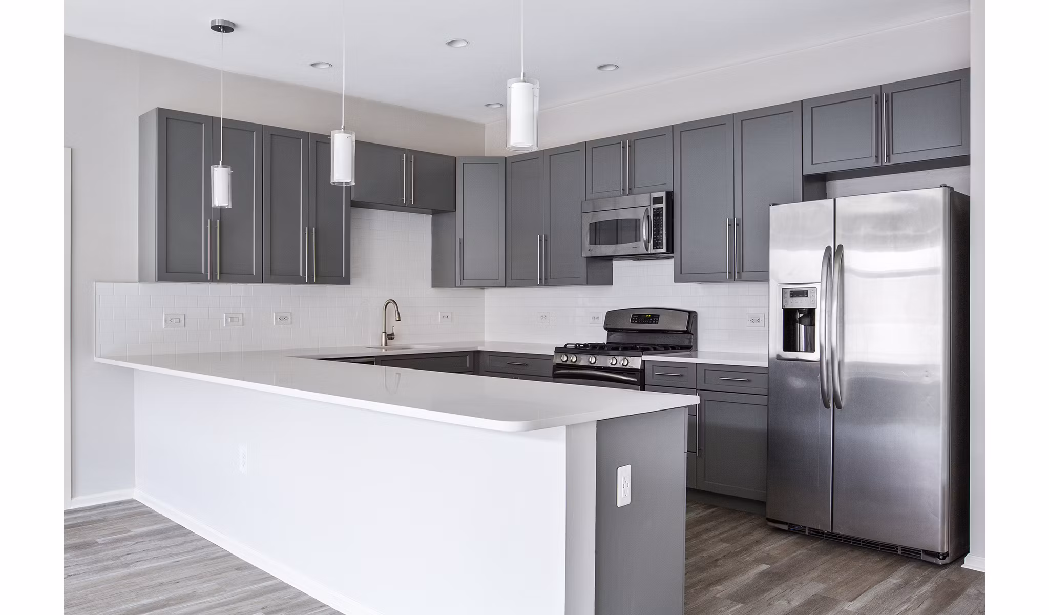 Modern kitchen with granite countertops and stainless steel appliances at 1000 Jefferson Street Apartments