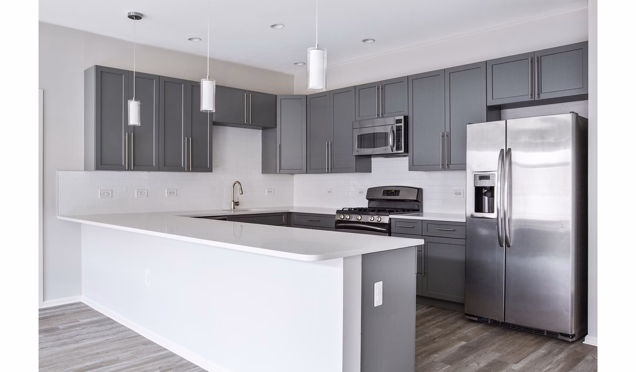 Modern kitchen with granite countertops and stainless steel appliances at 1000 Jefferson Street Apartments