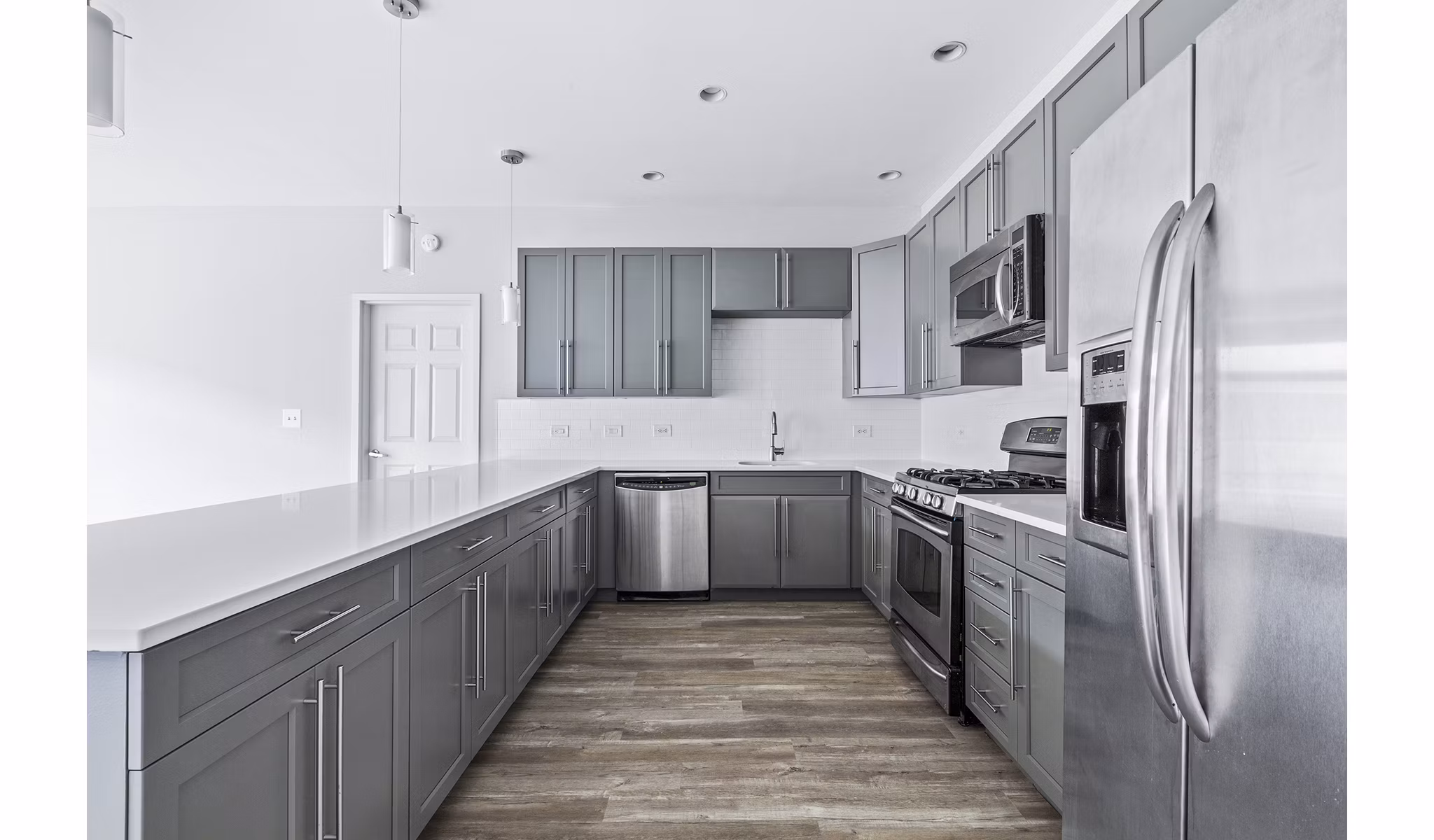 Modern kitchen with stainless steel appliances at 1000 Jefferson Street Apartments