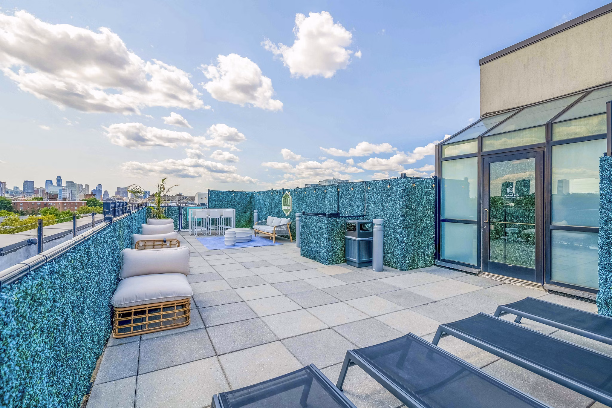 Patio with modern seating and city views at 1000 Jefferson Street Apartments
