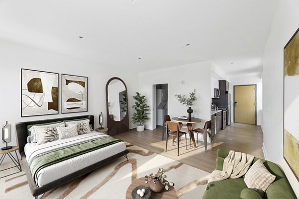 Cozy bedroom with ample natural light at Louis at 14th Apartments Modern design complements luxury apartment living