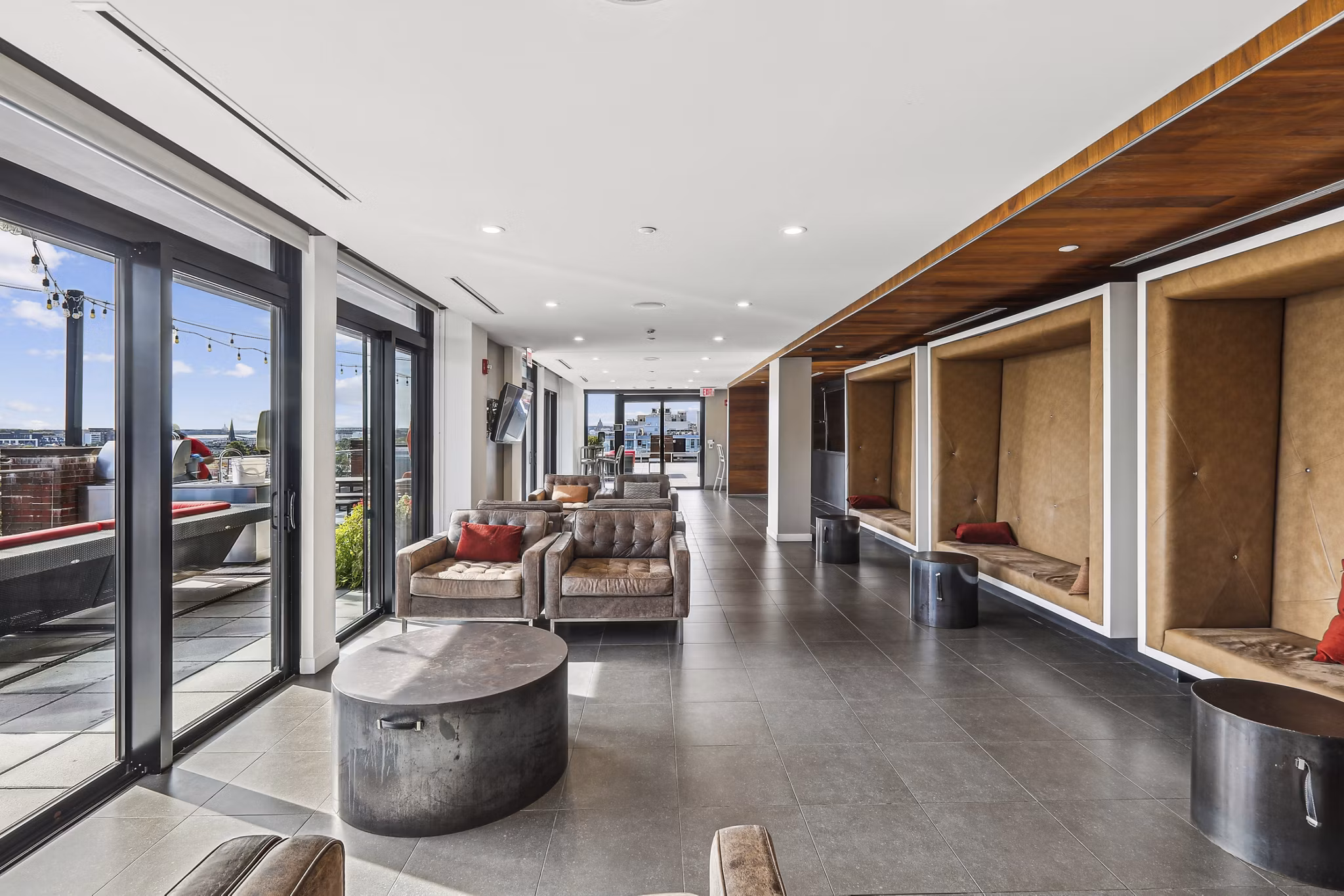 Game room with billiards and lounge area at The Louis Apartments, offering luxury living spaces for residents to enjoy and relax