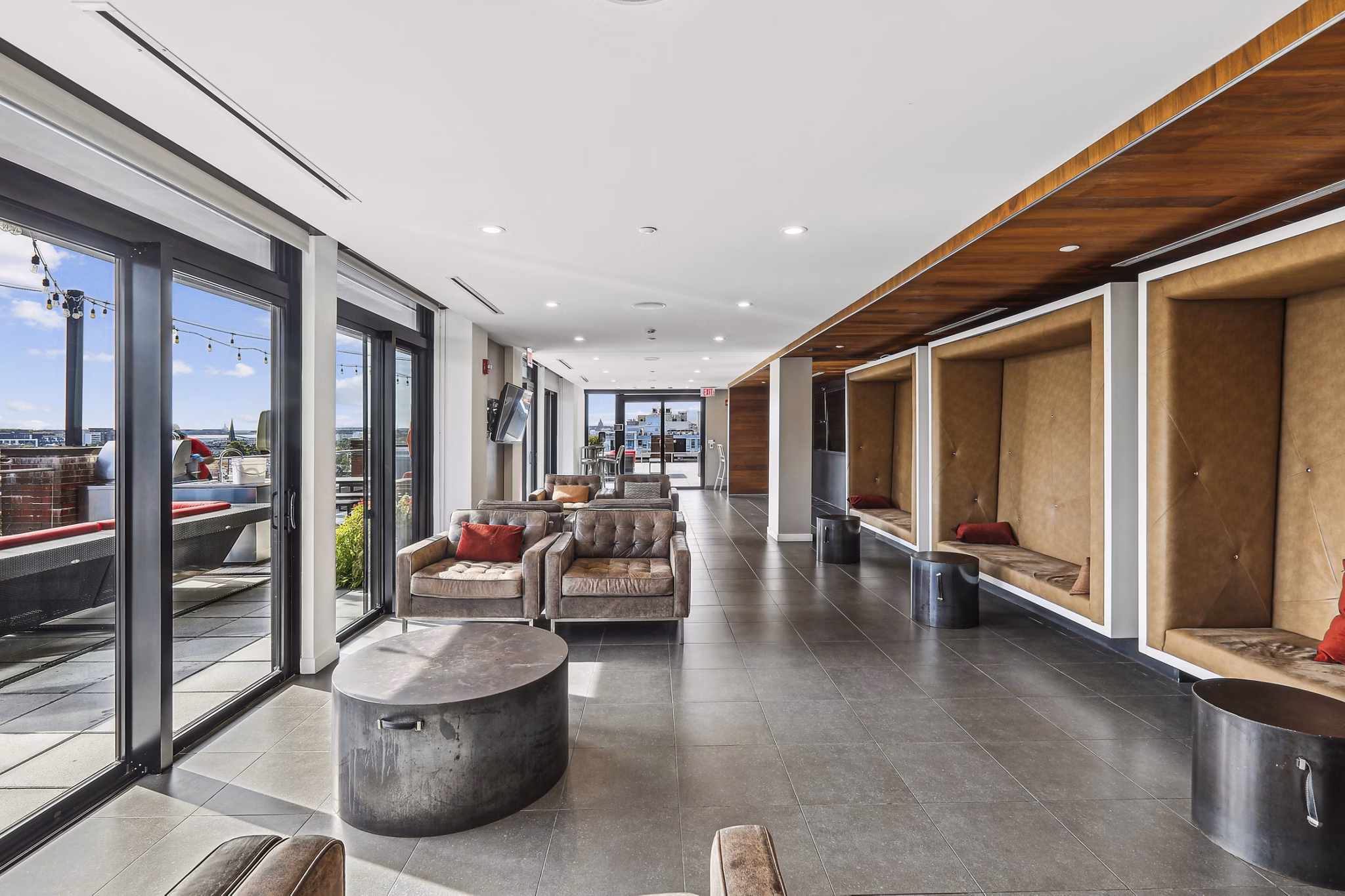 Game room with billiards and lounge area at The Louis Apartments, offering luxury living spaces for residents to enjoy and relax