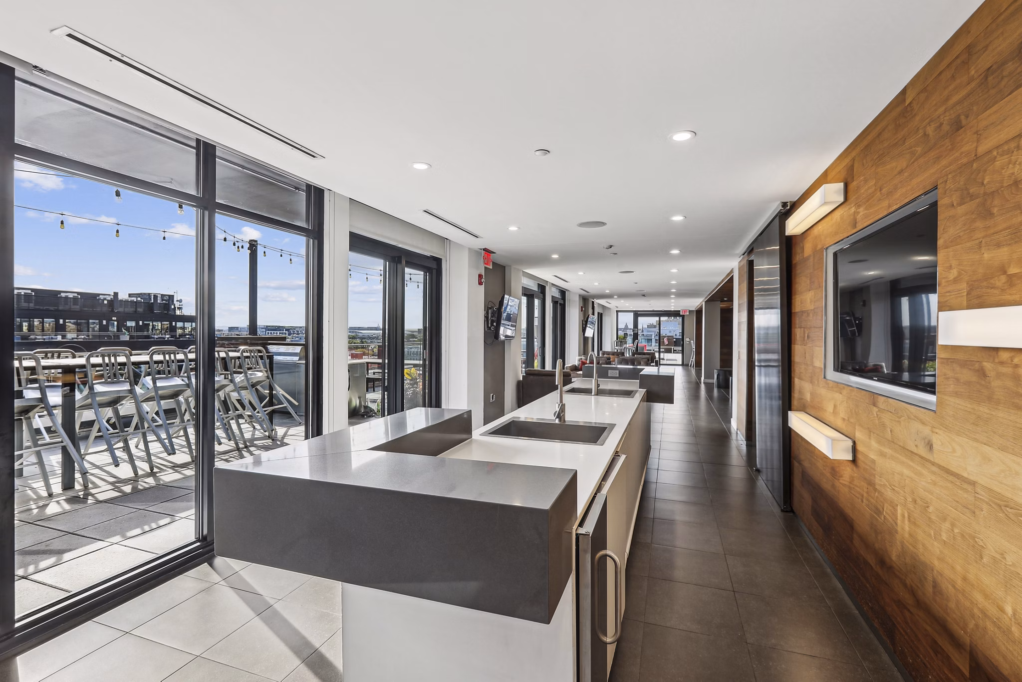 Modern clubhouse with cozy seating and entertainment area at The Louis Apartments, a Greystar luxury living community