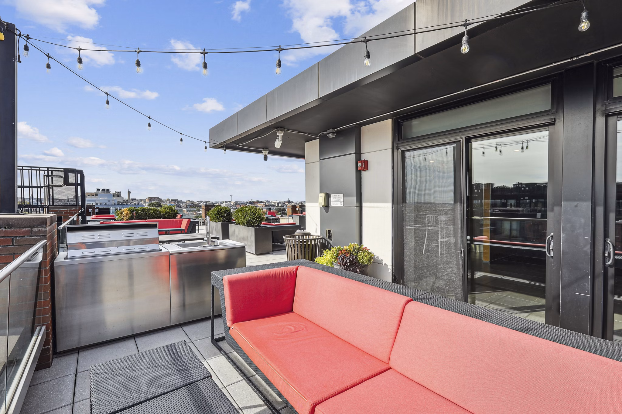 Clubhouse featuring modern design and seating areas at The Louis Apartments