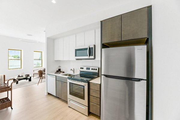 Modern kitchen with stainless steel appliances at Louis at 14th Apartments