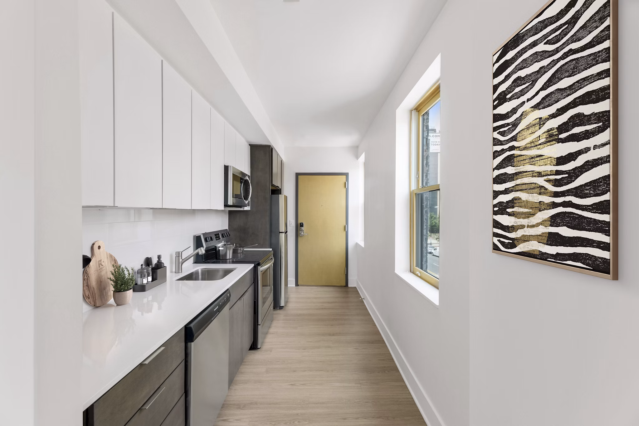 Modern kitchen with stainless steel appliances and granite countertops at Louis at 14th Apartments