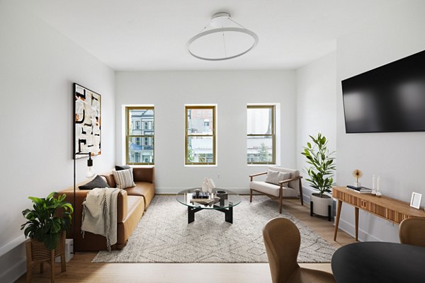 Contemporary living room with sleek design and ample natural light at Louis at 14th Apartments