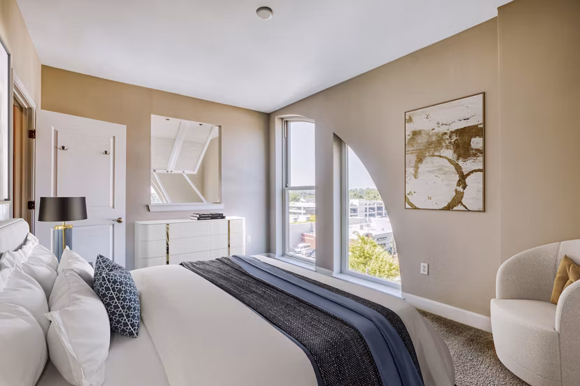 Cozy bedroom with ample natural light at Upstairs at Bethesda Row Apartments