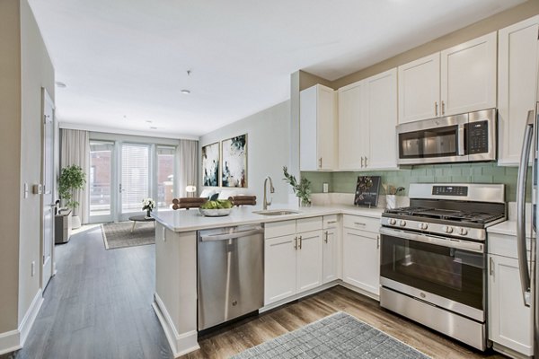 Modern kitchen with sleek countertops and stainless steel appliances at Upstairs at Bethesda Row Apartments luxury rentals