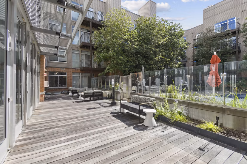 Modern outdoor patio with cozy seating at PerSei at Pike & Rose Apartments
