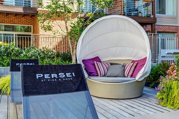 Modern outdoor patio with cozy seating at PerSei at Pike & Rose Apartments