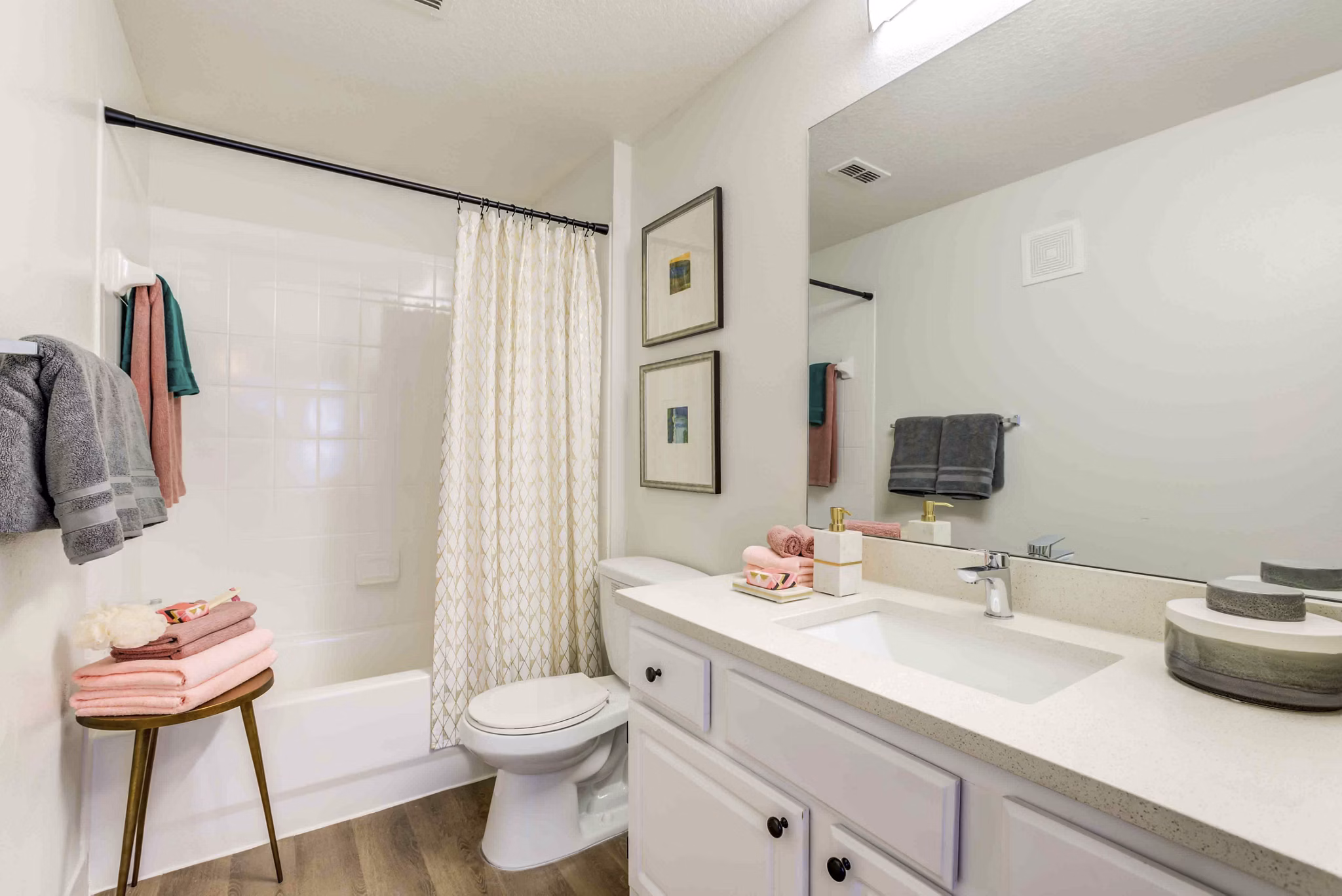Bathroom featuring modern fixtures and large mirror at Parks at Hunter's Creek Apartments, offering luxury living in a desirable community