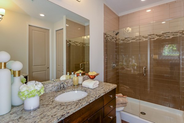 Bathroom with modern fixtures and large mirror at Urbana Apartments, Greystar luxury apartments in Lincoln Park