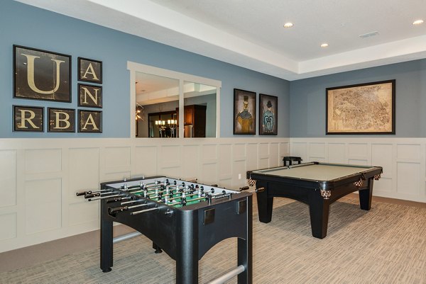 Game room featuring pool table and lounge seating at Urbana Apartments, a luxury community with recreational amenities