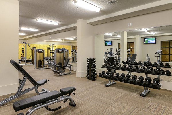 Fitness center with modern equipment at Urbana Apartments