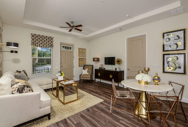 Modern living room with sleek furniture and large windows at Urbana Apartments
