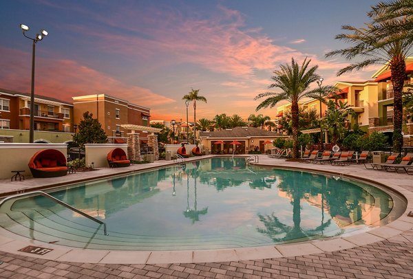Olympic-sized pool with sun loungers at Urbana Apartments offering luxury living and leisure in a vibrant community