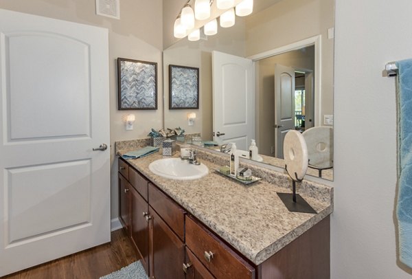 Bathroom featuring modern design and sleek fixtures at Town Center at Lakeside Village Apartments