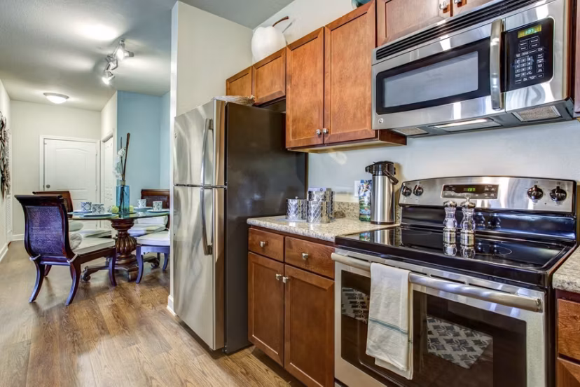 Modern kitchen featuring stainless steel appliances at Town Center at Lakeside Village Apartments
