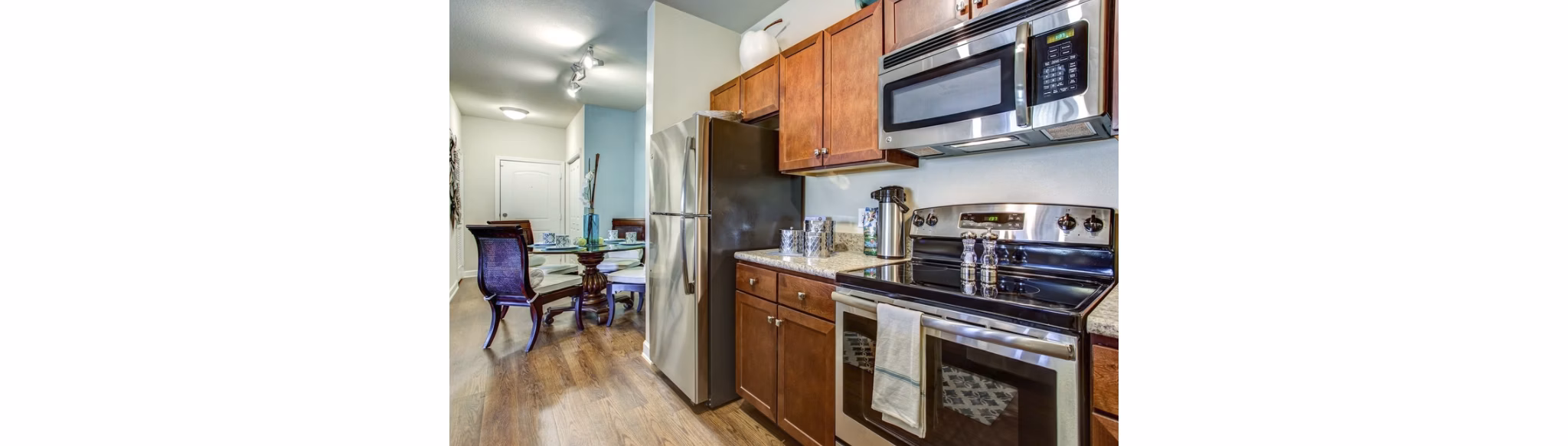 Modern kitchen featuring stainless steel appliances at Town Center at Lakeside Village Apartments