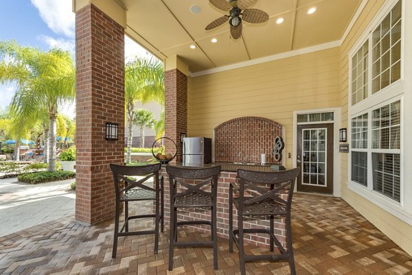 Expansive patio with outdoor seating at Town Center at Lakeside Village Apartments, perfect for leisure and social gatherings