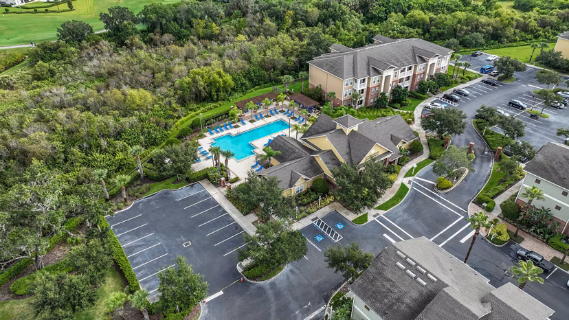 View of landscaped gardens and fountain at Town Center at Lakeside Village Apartments