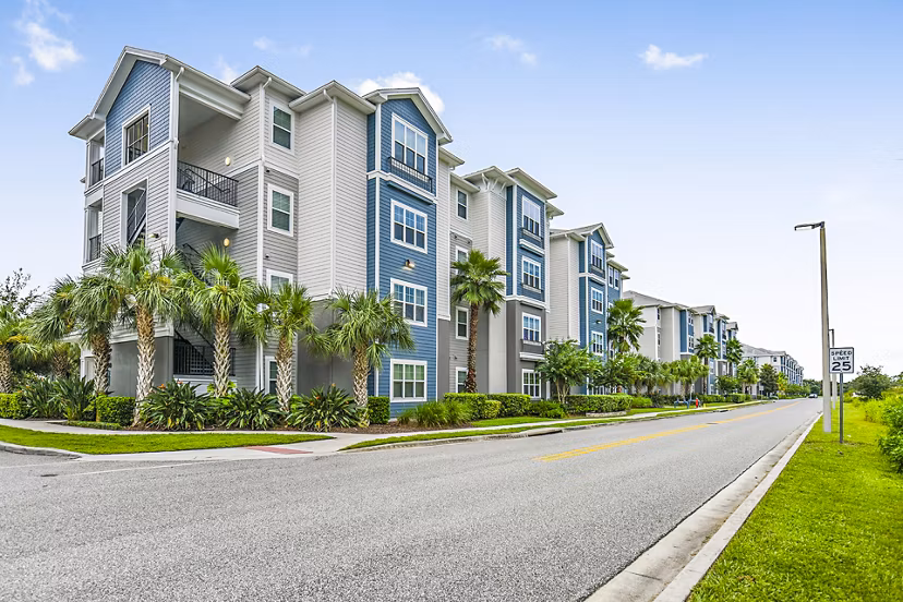 Windermere Cay: Elegant mid-rise apartments with palm-lined entrance in Winter Garden