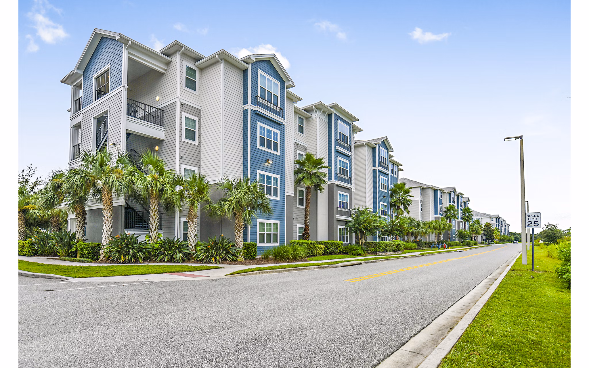 Windermere Cay: Elegant mid-rise apartments with palm-lined entrance in Winter Garden