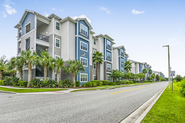 Windermere Cay: Elegant mid-rise apartments with palm-lined entrance in Winter Garden