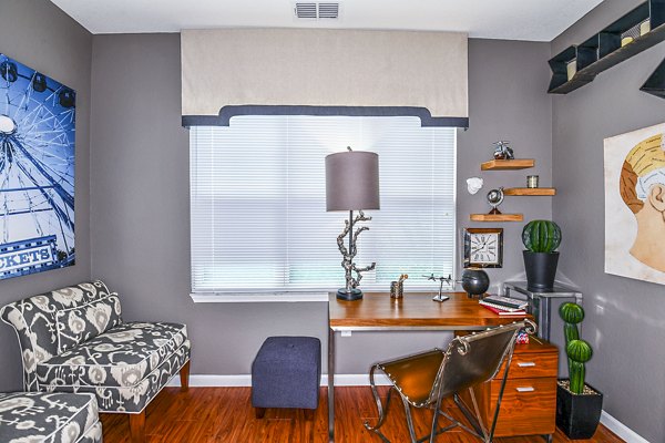 Home office with modern desk and ergonomic chair at Windermere Cay Apartments